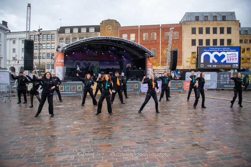 Staff from Royal & Derngate taking part in a flash mob at the Market Square in Northampton on Sunday, October 20, 2024, performing as part of a weekend of activities celebrating its official reopening. Photo by David Jackson.