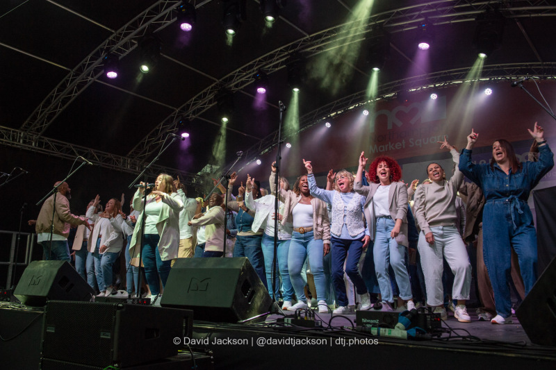 The Northants Sings Out Choir on stage at the Market Square in Northampton on Sunday, October 20, 2024, performing as part of a weekend of activities celebrating its official reopening. Photo by David Jackson.
