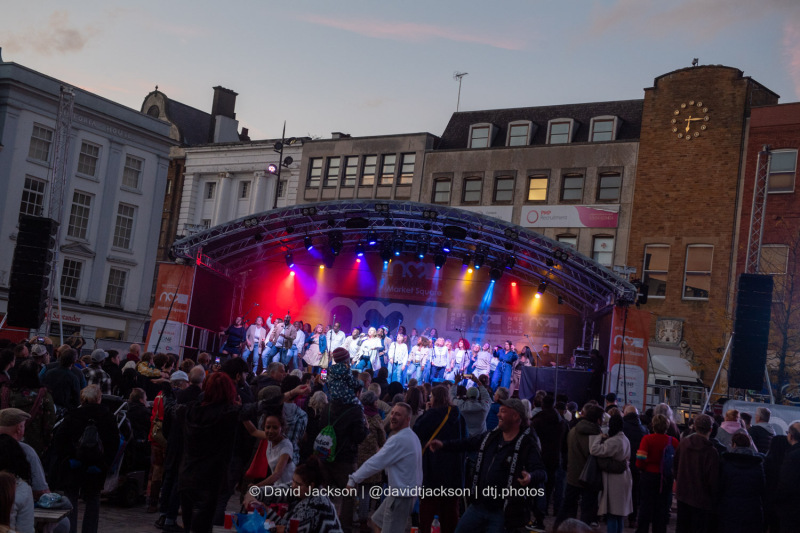 The Northants Sings Out Choir on stage at the Market Square in Northampton on Sunday, October 20, 2024, performing as part of a weekend of activities celebrating its official reopening. Photo by David Jackson.