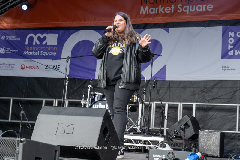 BBC Introducing’s Kerrie Cosh introducing acts on stage at the Market Square in Northampton on Saturday, October 19, 2024, as part of a weekend of activities celebrating its official reopening. Photo by David Jackson.