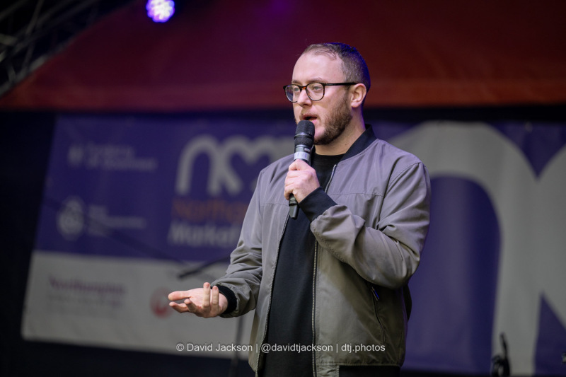 Host Tommy Gardner introducing acts at the Market Square in Northampton on Sunday, October 20, 2024, as part of a weekend of activities celebrating its official reopening. Photo by David Jackson.